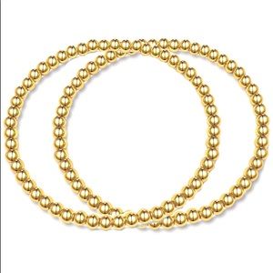 Two 4 mm stackable gold bracelets in pouch